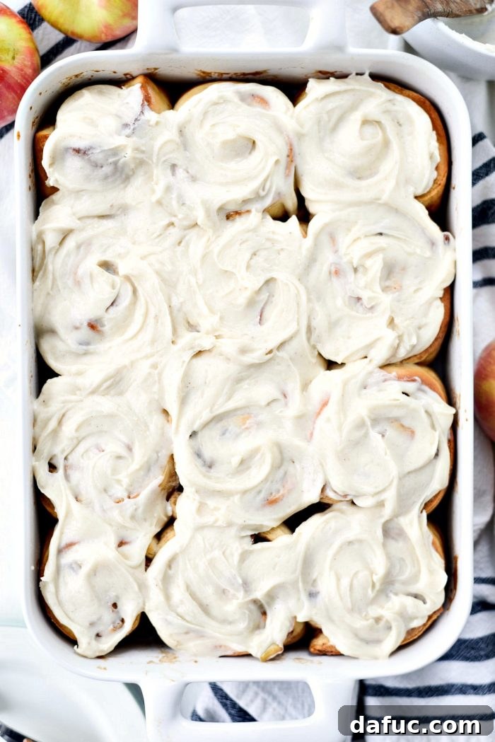 Warm Apple Pecan Chai Cinnamon Rolls cooling before icing. SimplyScratch.com