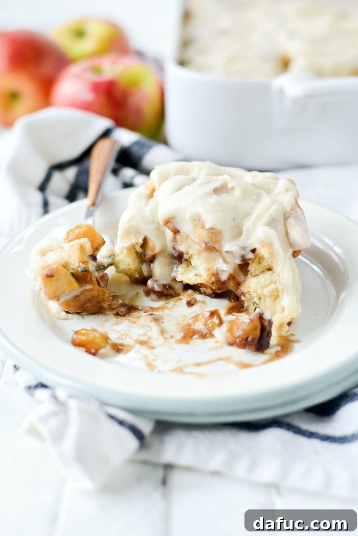 Stack of freshly baked and iced Apple Pecan Chai Cinnamon Rolls. SimplyScratch.com