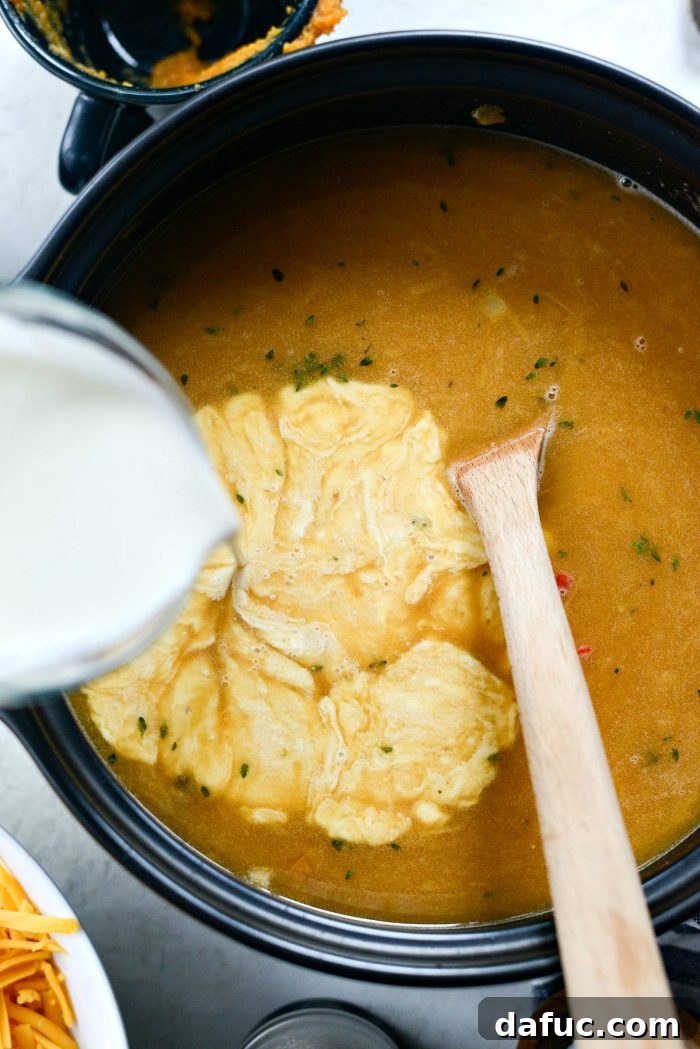 Harvest Ale & Creamy Cheddar Pumpkin Soup 14 The Pumpkin Beer Cheese Soup simmering gently on the stovetop, thickening to a creamy consistency.