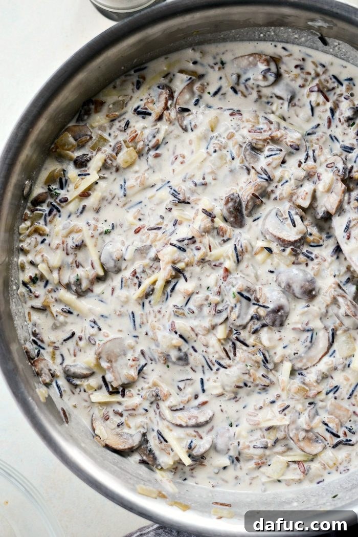Hearty Mushroom Wild Rice Bake 11 Mushroom and wild rice mixture transferred to a baking dish, ready for the oven.