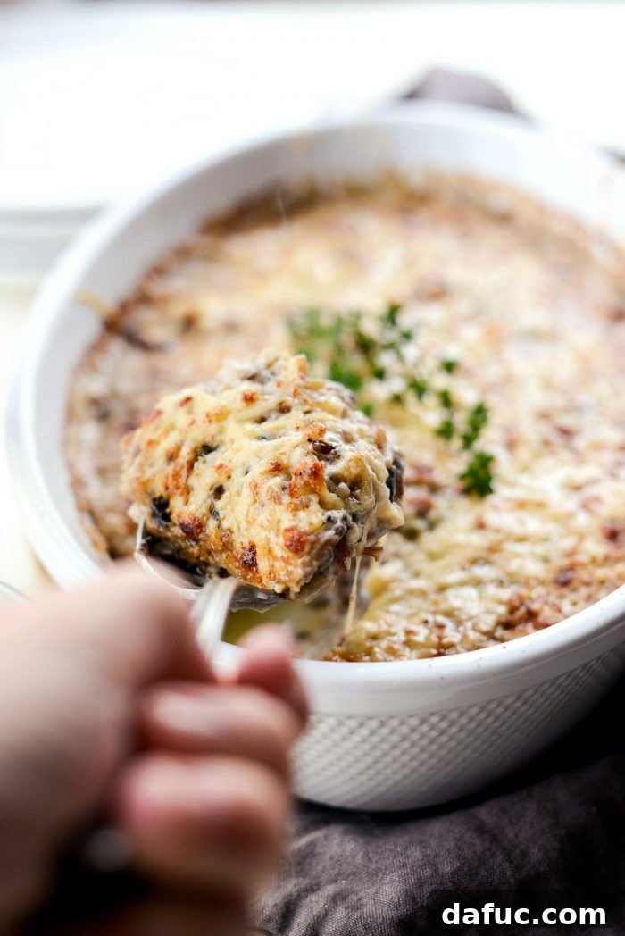 Hearty Mushroom Wild Rice Bake 15 Close-up of the melted, bubbly Gruyere cheese topping on the Mushroom Wild Rice Casserole.