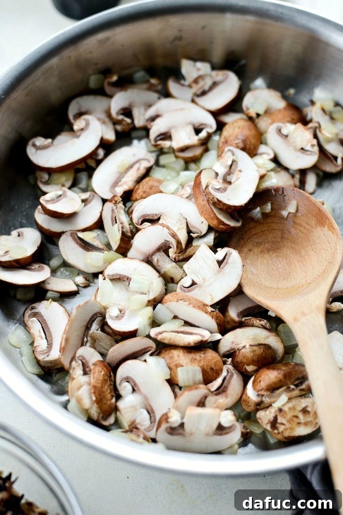 Hearty Mushroom Wild Rice Bake 6 Sautéed yellow onions turning translucent in a skillet.