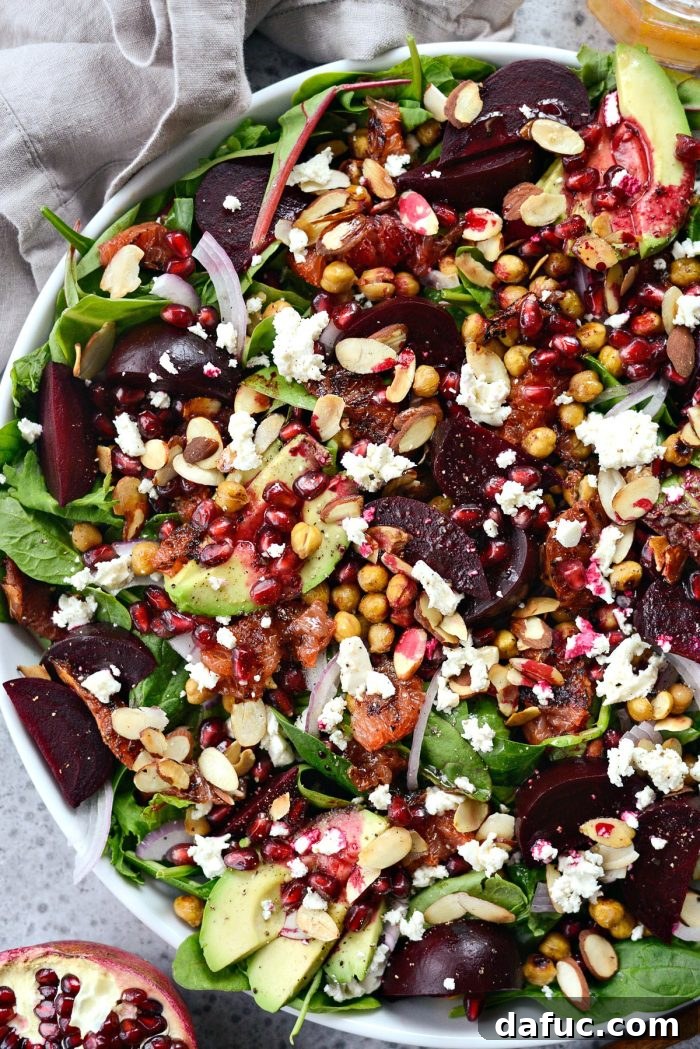 Vibrant Roasted Grapefruit Beet Salad with power greens and pomegranate for a festive meal.