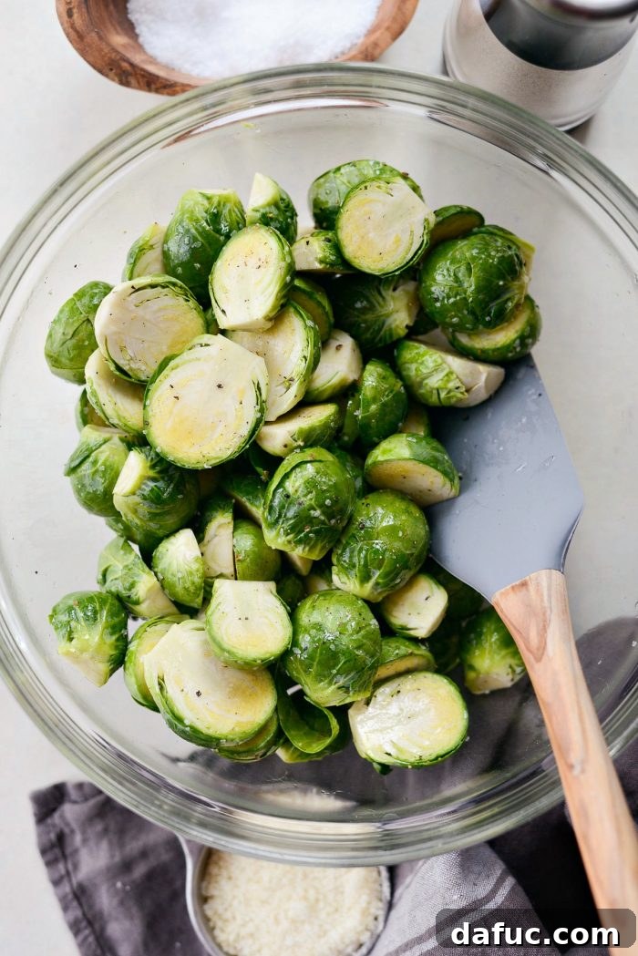 Close-up of seasoned Brussels sprouts in a bowl, ready for air frying.