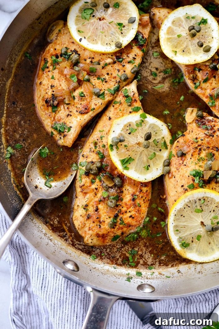 Bright & Healthy Chicken Piccata 2 Golden-brown Lighter Chicken Piccata with lemon slices