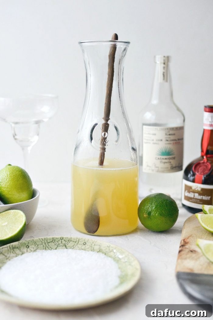 Signature Beergarita 7 A glass pitcher filled with the freshly mixed margarita base, ready for serving.