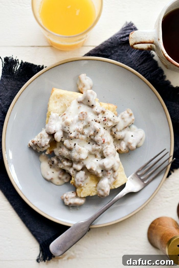 Delicious Homemade Turkey Sausage Breakfast Gravy served over fluffy biscuits, a lighter and healthier alternative to traditional gravy. Perfect for a comforting brunch.