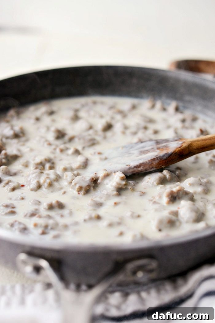 Finished turkey sausage breakfast gravy, thick and ready to be served, in a skillet.