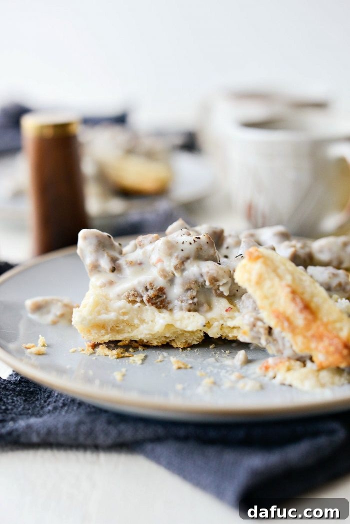 A beautifully plated serving of Turkey Sausage Breakfast Gravy over biscuits, ready to be enjoyed.
