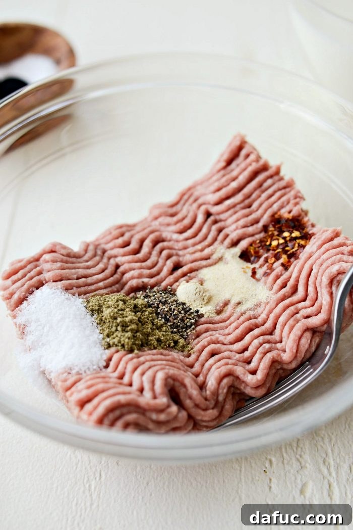 Ingredients for Homemade Turkey Sausage Breakfast Gravy laid out on a counter, including ground turkey, spices, flour, and milk.