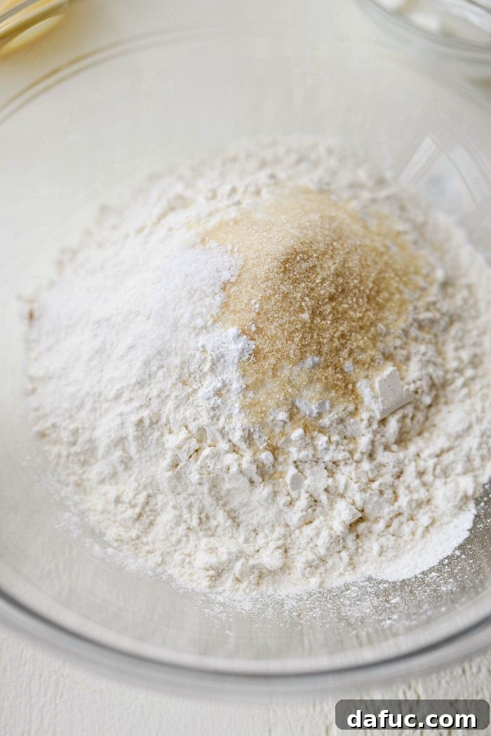 Cloud-Like Greek Yogurt Biscuits 4 Overhead shot of all the ingredients for Greek Yogurt Biscuits laid out on a kitchen counter.