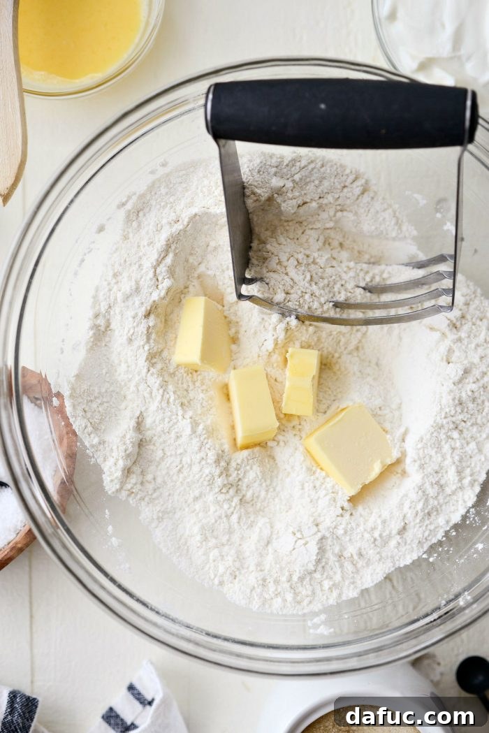 Cloud-Like Greek Yogurt Biscuits 6 A rubber spatula stirring the dry ingredients in a mixing bowl.