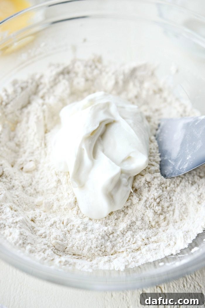 Cloud-Like Greek Yogurt Biscuits 8 Using a pastry cutter to cut cold butter into the flour mixture.
