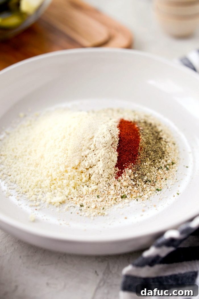 Crispy Air-Fried Zucchini Sticks 9 Shallow bowl containing Italian breadcrumbs, Parmesan cheese, and spices for zucchini fries.