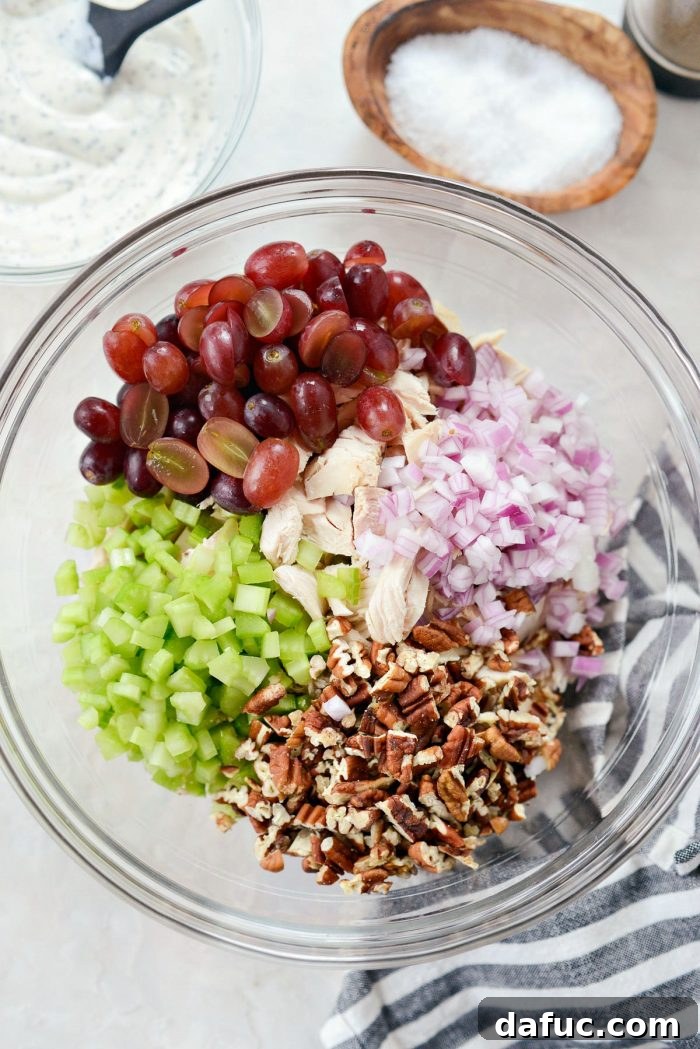 Zesty Greek Yogurt Chicken Salad with Sweet Grapes and Toasted Pecans 7 Mixing bowl with cooked chicken, grapes, celery, onion and chopped toasted pecans.