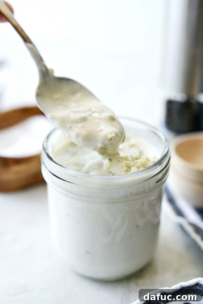 Tangy Greek Yogurt Blue Cheese Dressing 10 A spoonful of Greek Yogurt Blue Cheese Dressing, showing its creamy texture