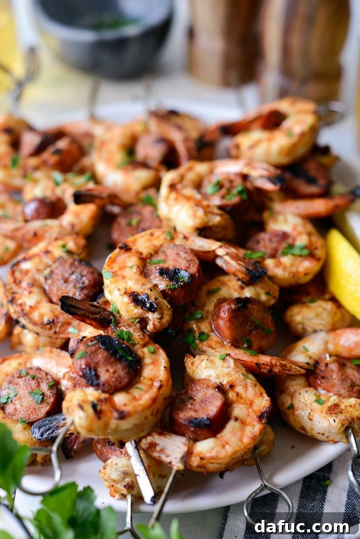 Close-up shot of perfectly grilled Cajun Shrimp and Andouille Skewers, highlighting the char and vibrant colors.