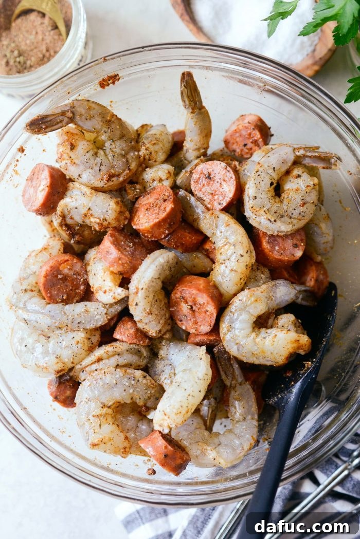 All ingredients for Cajun Shrimp and Andouille Skewers thoroughly tossed together in a bowl, ready for skewering.