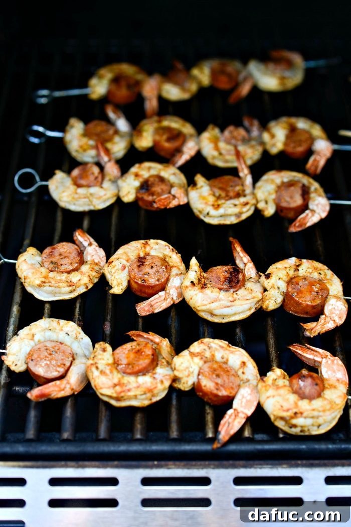 Freshly grilled Cajun Shrimp and Andouille Skewers with perfect char marks, removed from the grill.