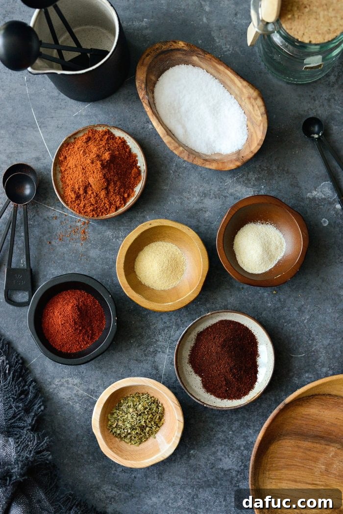 Smoky Chipotle Spice Mix 3 A selection of individual spices, including chipotle chili powder, cumin, and paprika, laid out for blending.