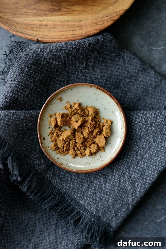 Smoky Chipotle Spice Mix 4 A small dish filled with rich brown ground cumin, ready for the seasoning blend.