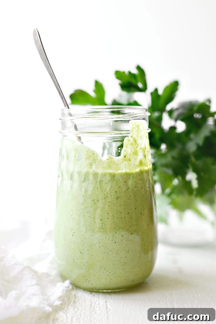 Freshly blended Greek Yogurt Green Goddess Salad Dressing in a jar