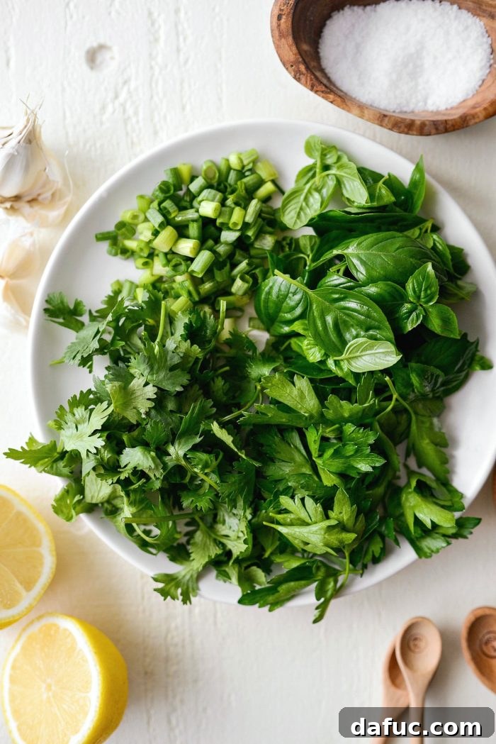 Assortment of fresh herbs and green onions for the dressing