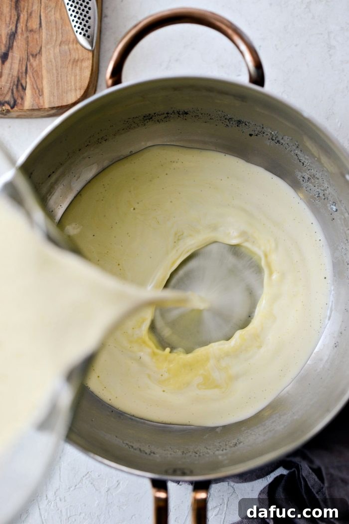 Velvet Vanilla Gelato 14 Pouring the egg and milk mixture back into the saucepan.