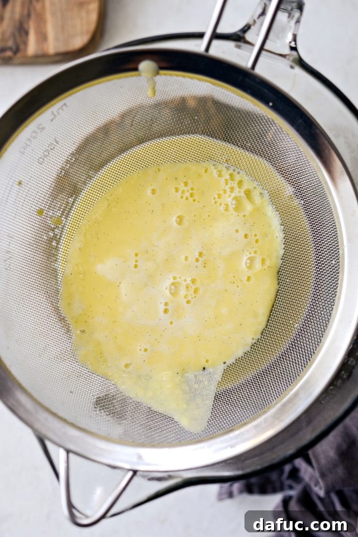 Velvet Vanilla Gelato 17 Straining the gelato base through a fine mesh sieve to remove impurities.