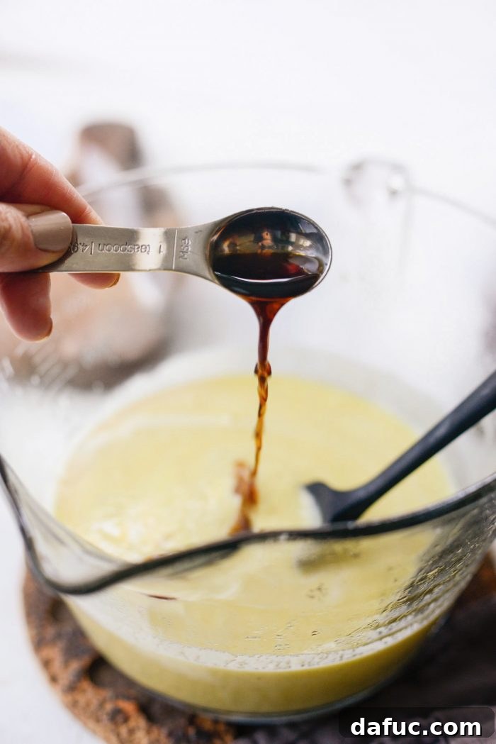 Velvet Vanilla Gelato 18 Adding 1 teaspoon of vanilla extract to the strained gelato base.