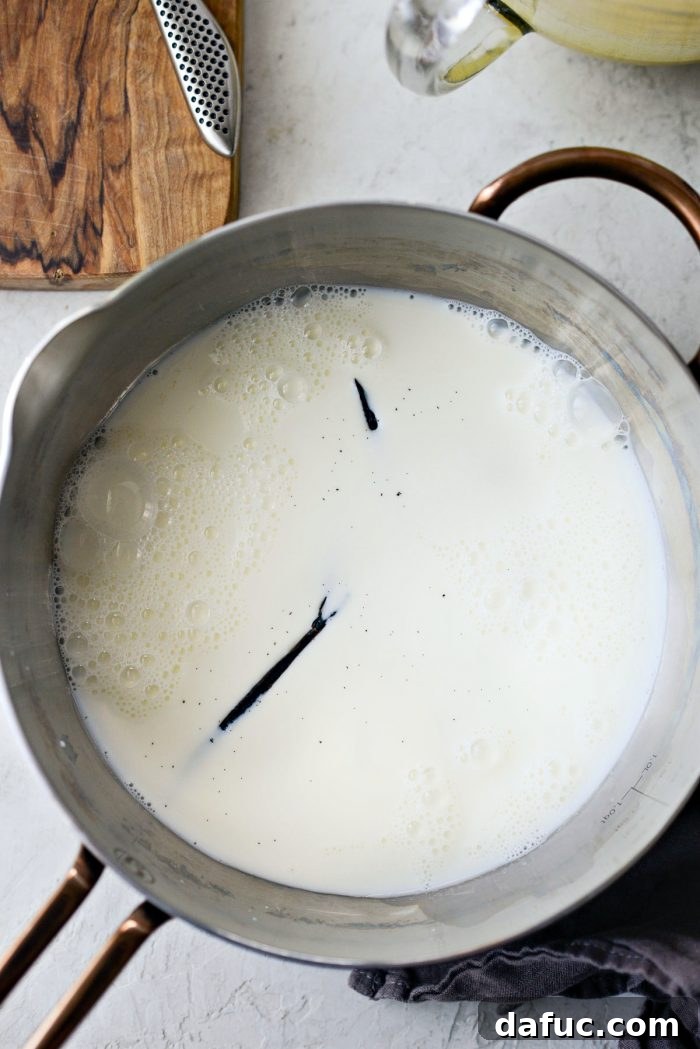 Velvet Vanilla Gelato 10 Vanilla bean dropped into milk in a saucepan.