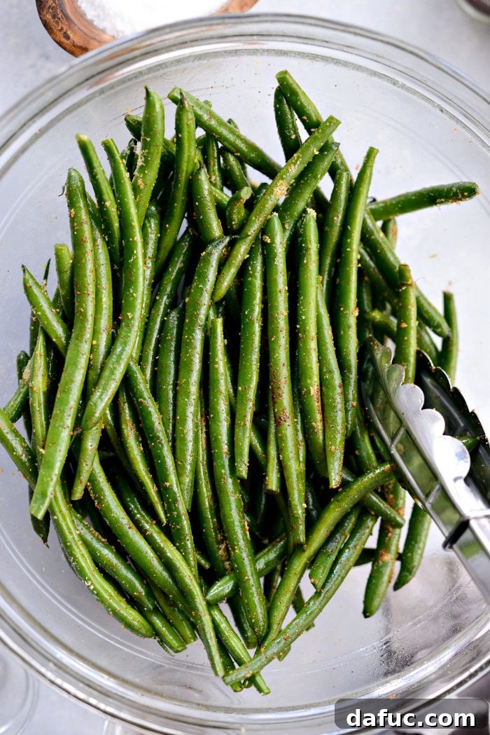 Crispy Air Fryer Green Beans 8 Seasoned green beans being tossed vigorously to distribute spices