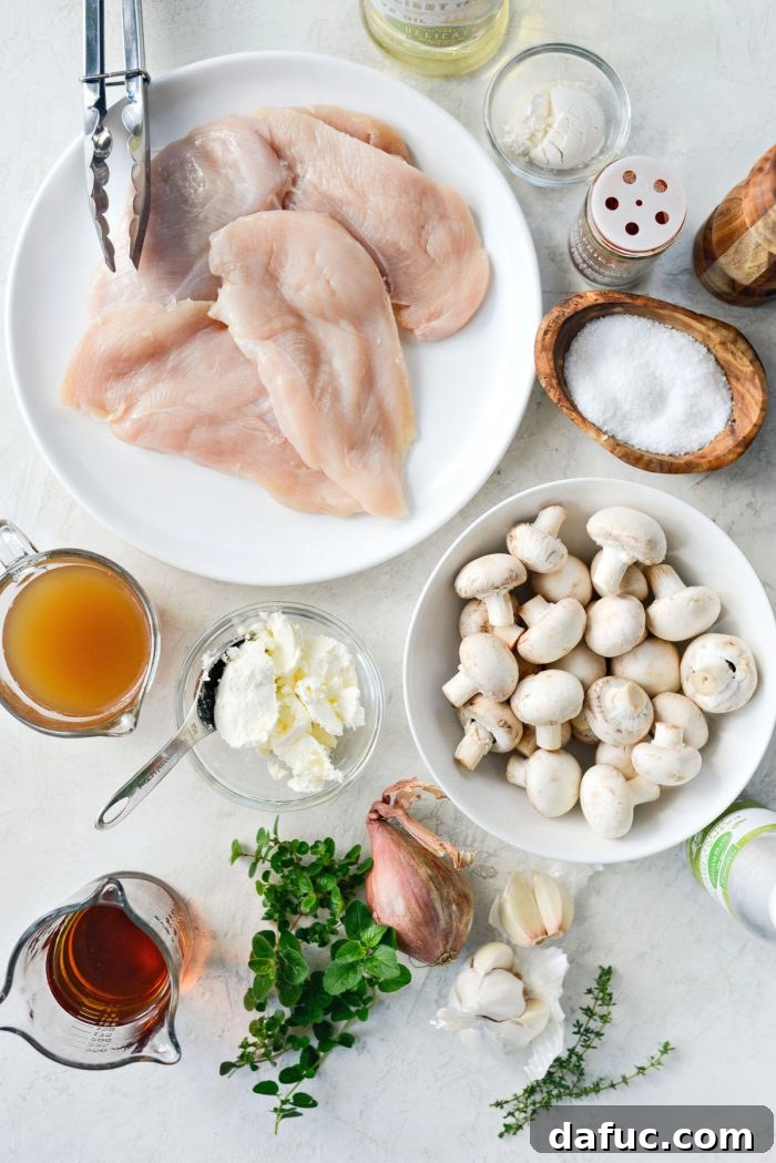 A flat lay of all fresh and dry ingredients required for Lighter Chicken Marsala, neatly arranged on a rustic wooden surface.