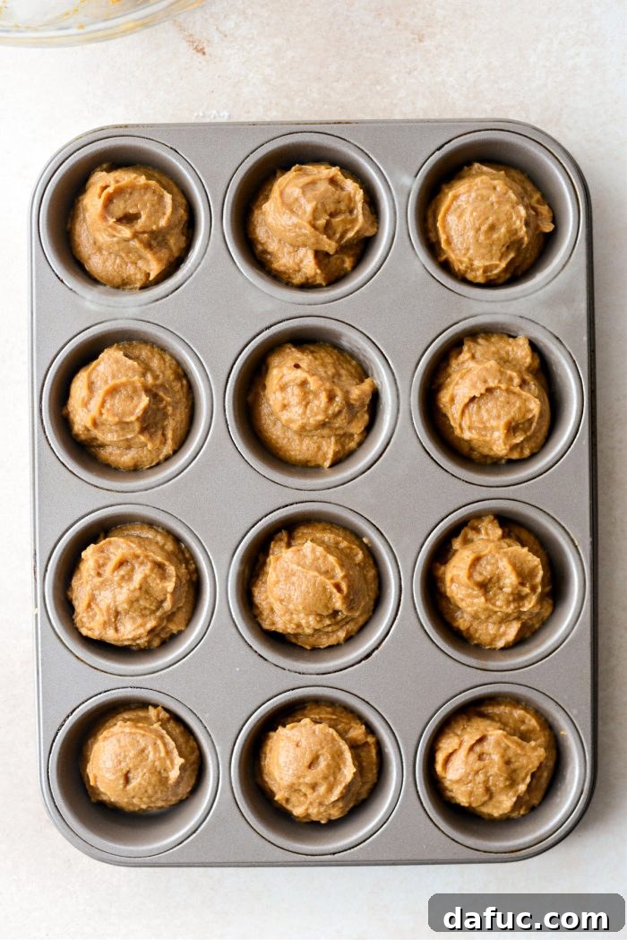 Pumpkin pie batter divided among a greased muffin tin