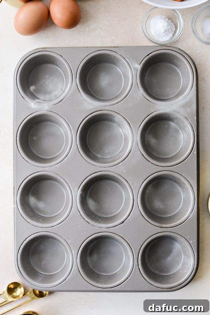 Greased muffin tin ready for baking