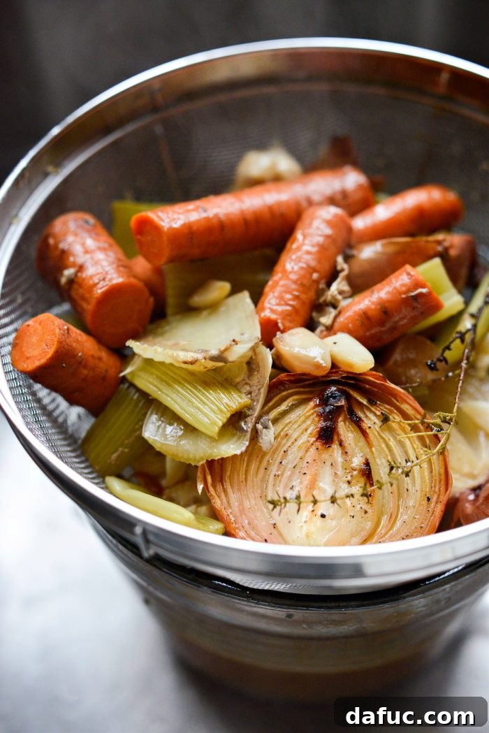Delicious Gravy, Made in Advance 13 strain broth - Straining the broth through a mesh sieve