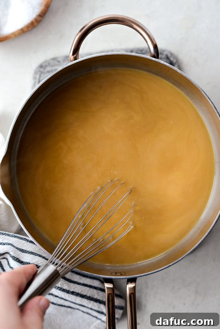 Delicious Gravy, Made in Advance 21 simmer, whisking often, until thickened - Gravy simmering on the stove