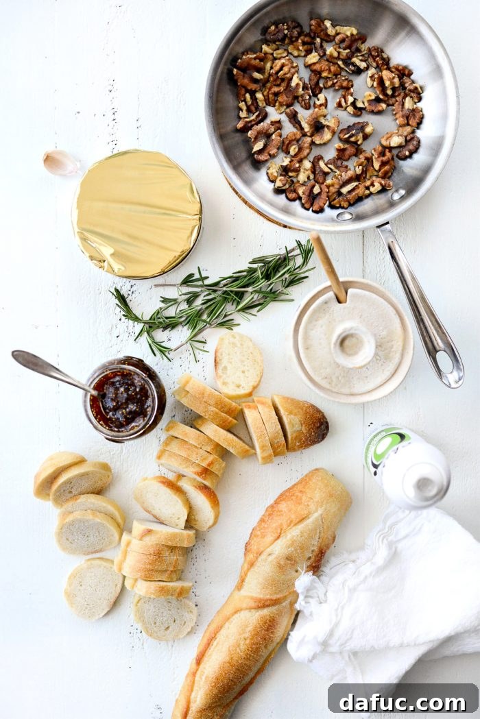 Honey Baked Brie with Fig Jam and Walnuts appetizer beautifully presented on a wooden board.