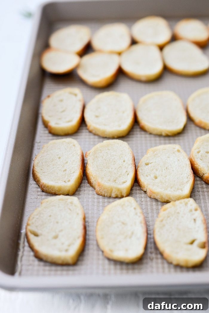 Baguette slices being toasted to make crostini.