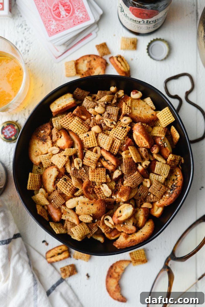 The Ultimate Everything Bagel Chex Mix 12 Close-up of the cooled Everything Plus the Bagel Chex Mix ready for snacking, highlighting the rich seasoning on various crunchy components.