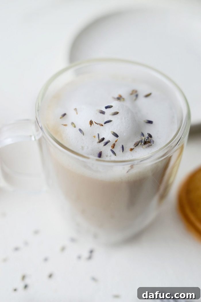 A London Fog Tea Latte accompanied by a few French butter cookies, suggesting a cozy pairing.