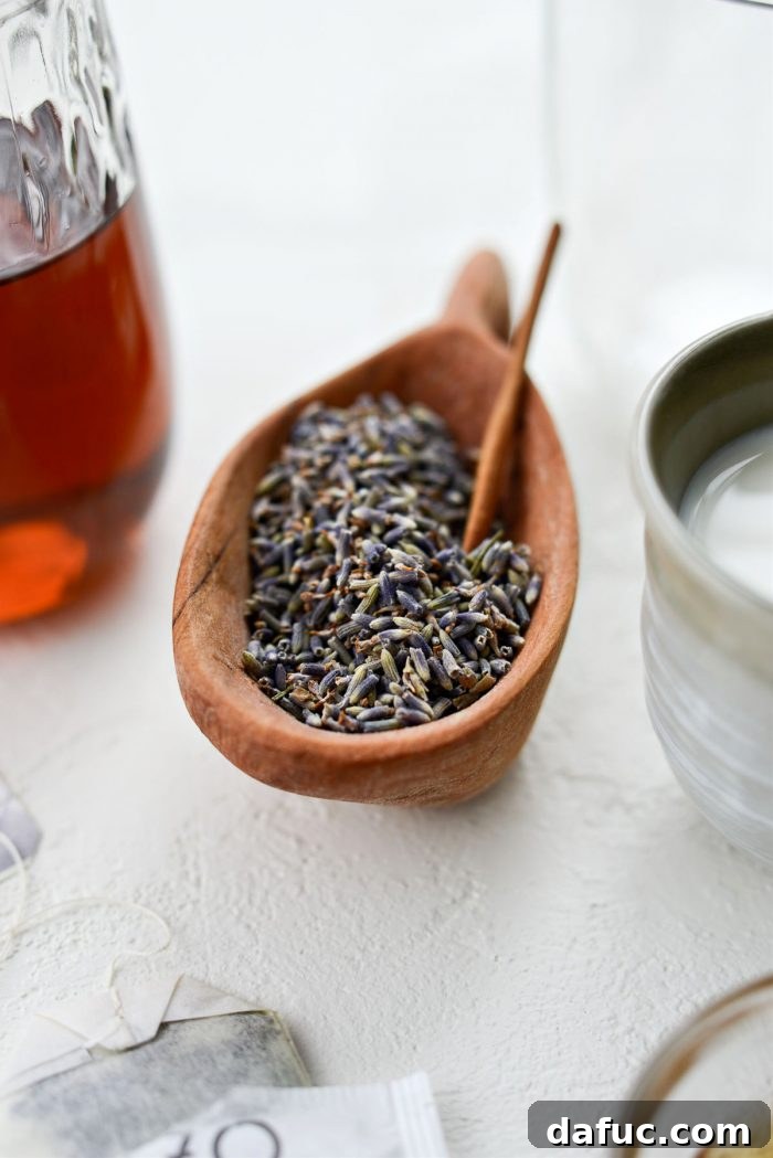 Dried culinary lavender in a rustic wooden bowl, ready to be used in the London Fog Tea Latte recipe.