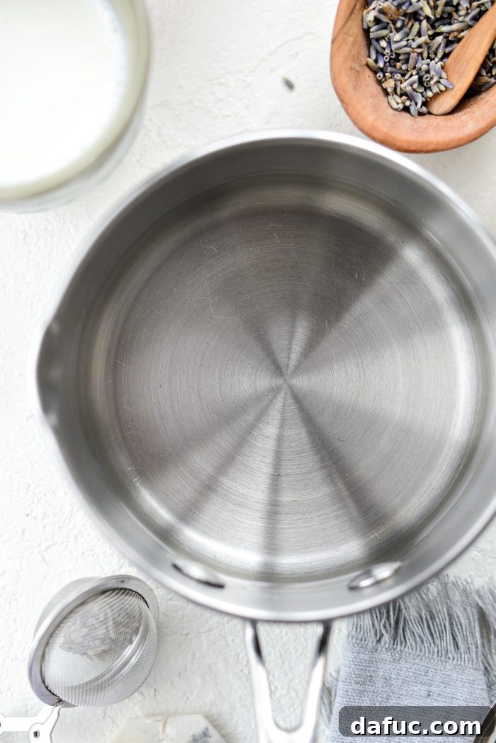 Water boiling in a saucepan on the stove, the first step in preparing the London Fog Tea Latte.