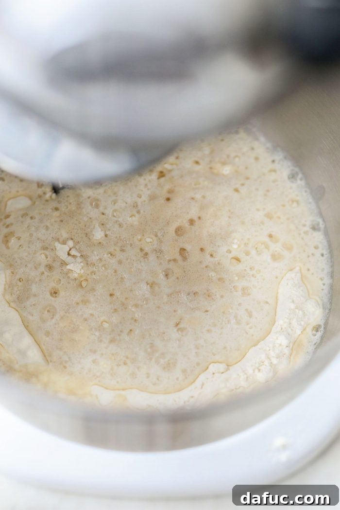 Ultimate Focaccia Pizza 9 Adding the yeast water to the flour in the mixing bowl.