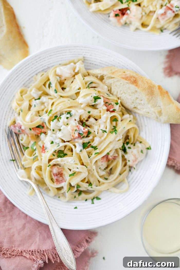 Garlicky Lobster Fettuccine Alfredo with crusty bread and wine.
