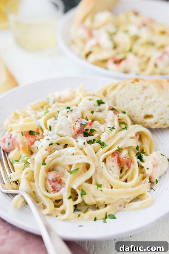 white bowl of Garlicky Lobster Fettuccine Alfredo