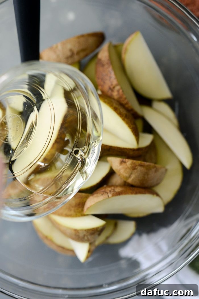 Potato Wedges and Olive Oil in a Mixing Bowl