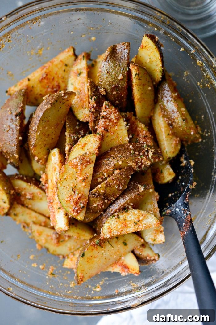 Tossing Potato Wedges in Oil, Herbs, and Spices for Even Coating