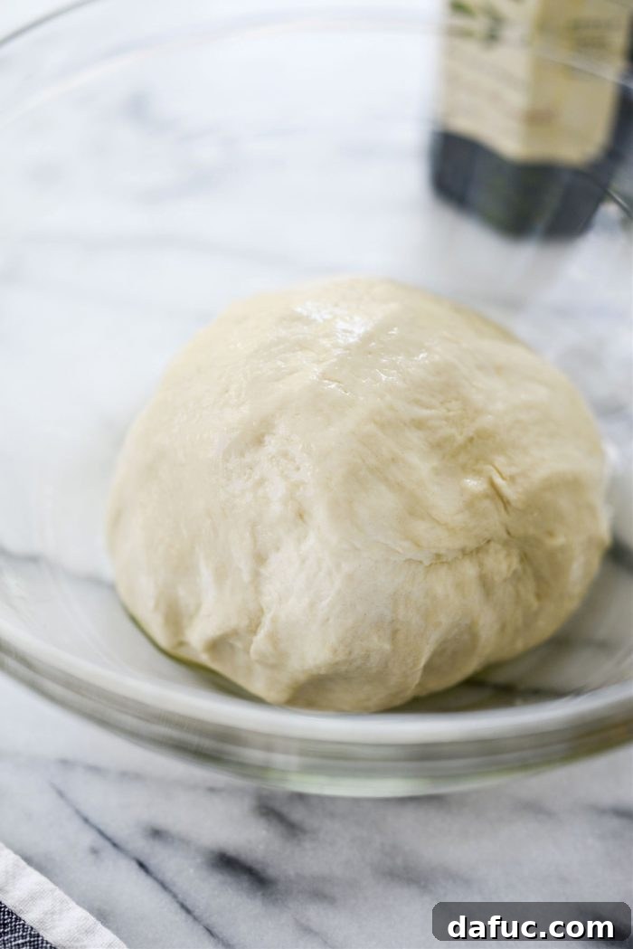 Bite-Sized Pita Pockets 12 Transferring perfectly kneaded pita dough to an olive oiled bowl