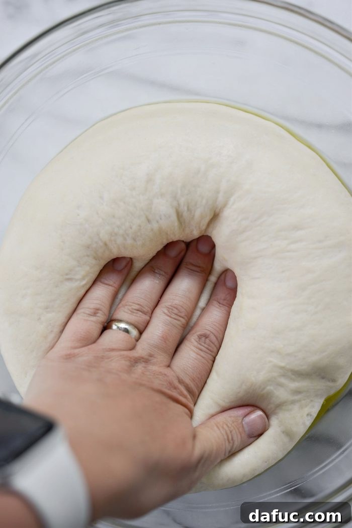 Bite-Sized Pita Pockets 14 Deflating beautifully risen pita dough by gently pressing out the trapped air